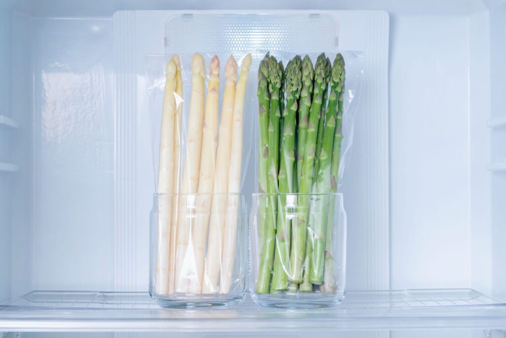 冷蔵庫の中で保存するグリーンとホワイトのアスパラガス